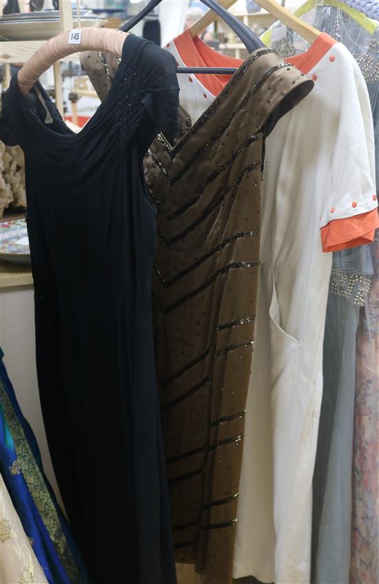 A 1930s/40s cream and orange day dress, black cocktail dress and a brown bead dress